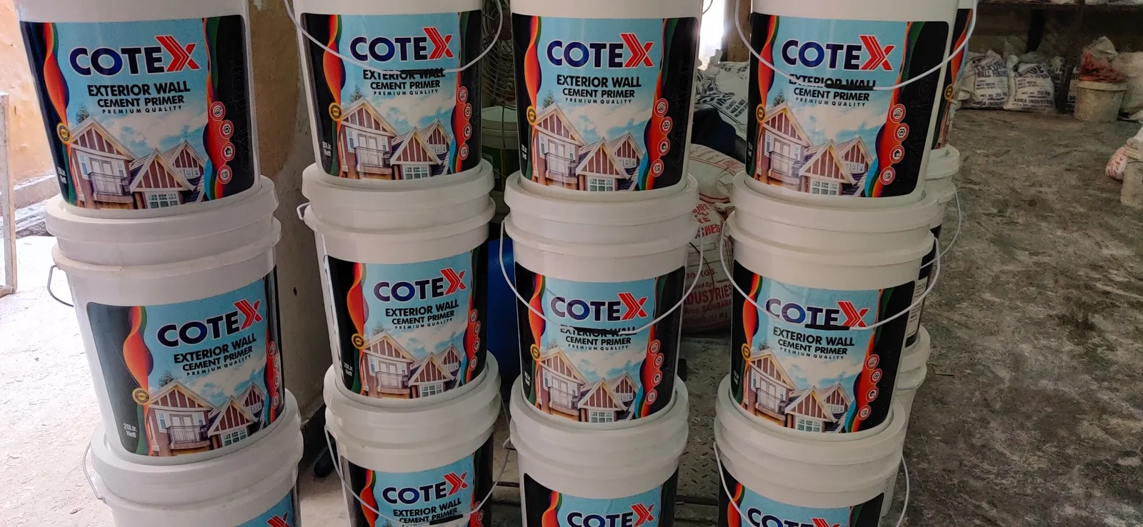 Cotex Exterior Wall Cement Primer buckets stacked after filling