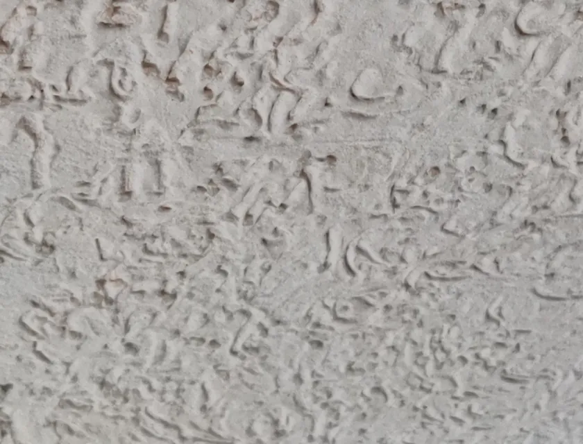 Skip trowel texture — stamped plaster relief, applied and photographed at the Asra works